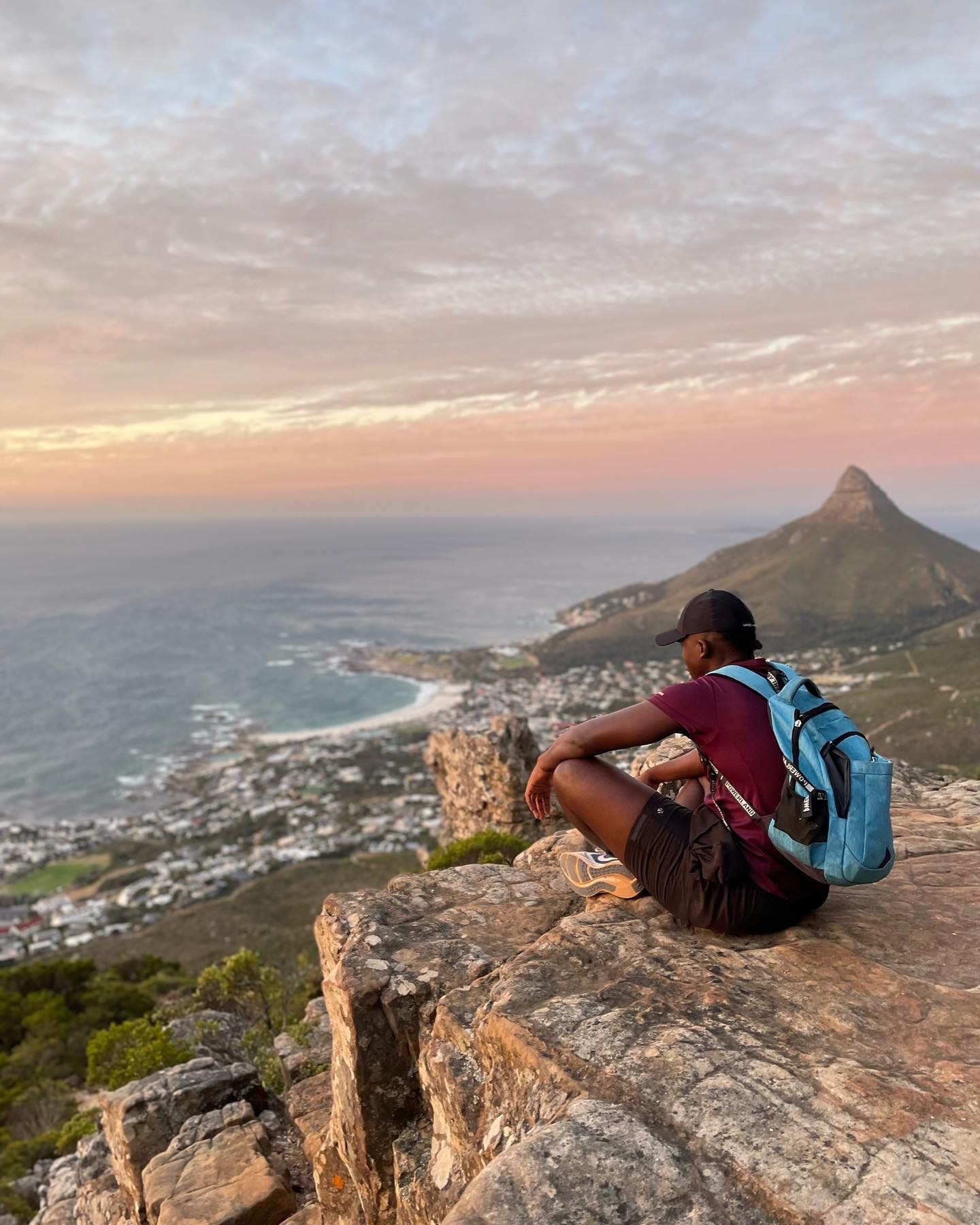 Takudzwa standing outdoors with a scenic background